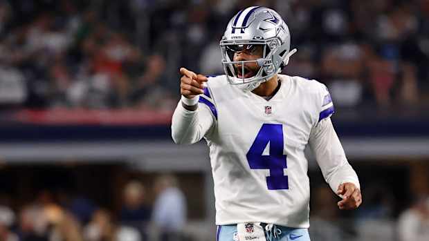 Dak Prescott points with one hand